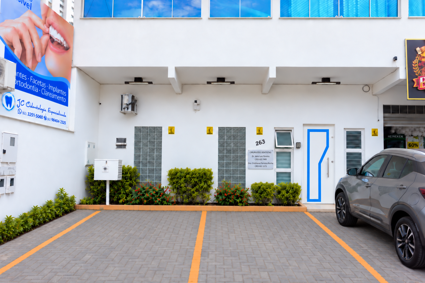 Fachada da JC Odontologia Especializada, na Rua C-236, Jardim América, com estacionamento na frente e a placa dos cirurgiões-dentistas Dr. Jairo Luiz Pereira, CRO-GO 7400, e Dra. Cristhiane Ferreira Rocha, CRO-GO 3373.